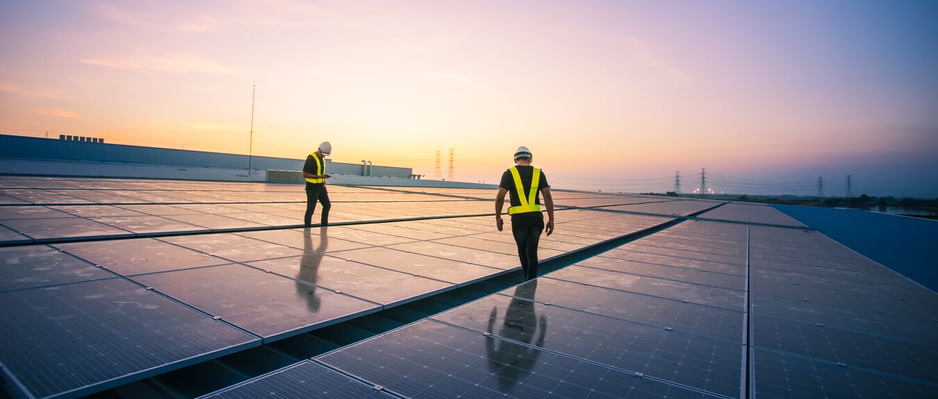 Technology solar cell, Engineer service check installation solar cell on the roof of factory on the morning. Silhouette technician inspection and repair solar cell on the roof of factory.